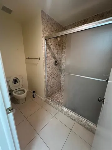a bathroom with a shower and toilet