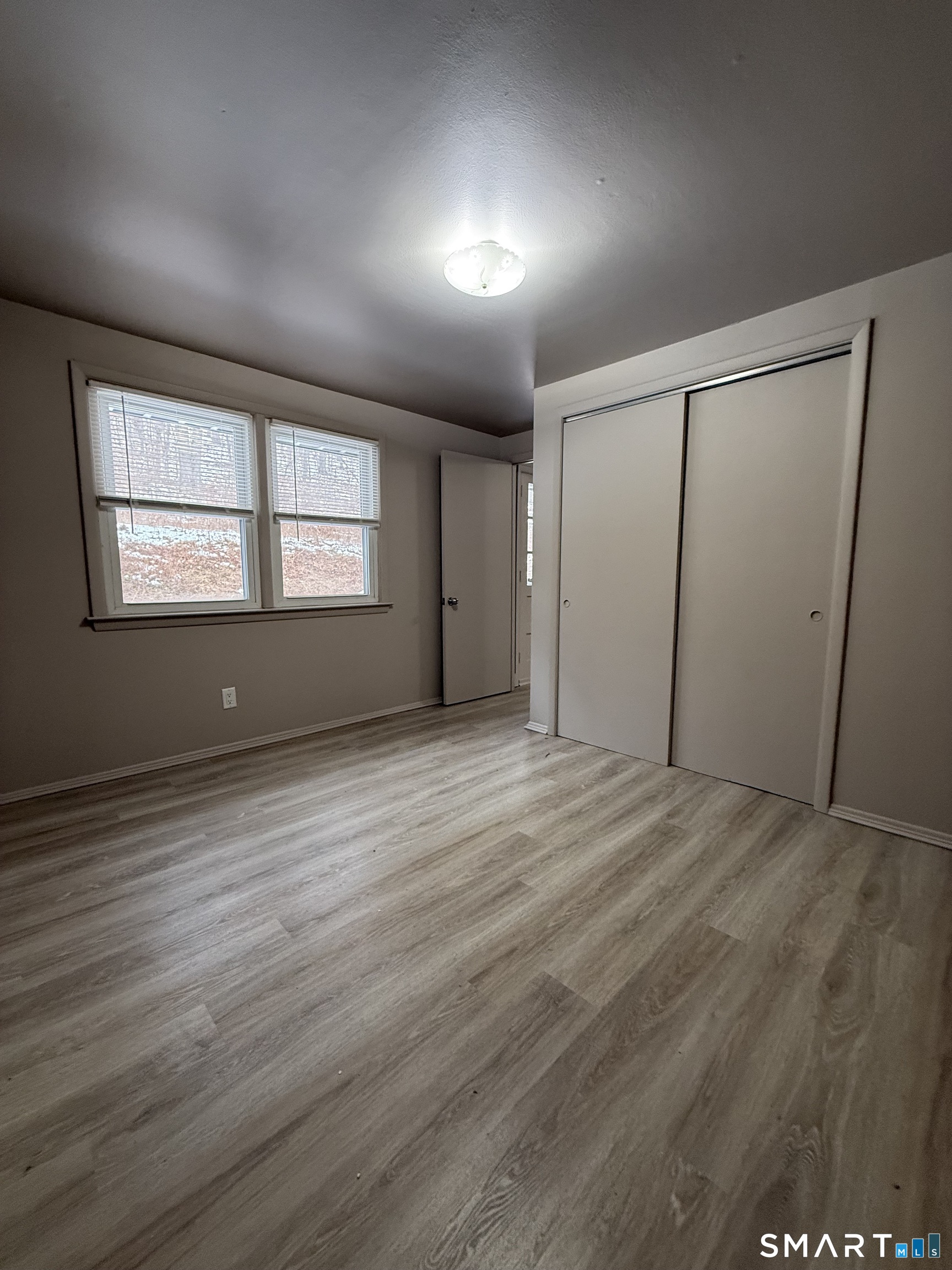 30 Bungay Road, Unit 5 Seymour, CT 06483 - Photo 12 of 14 an empty room with wooden floor and windows