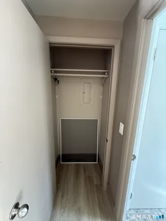 a view of walk in closet with wooden floor