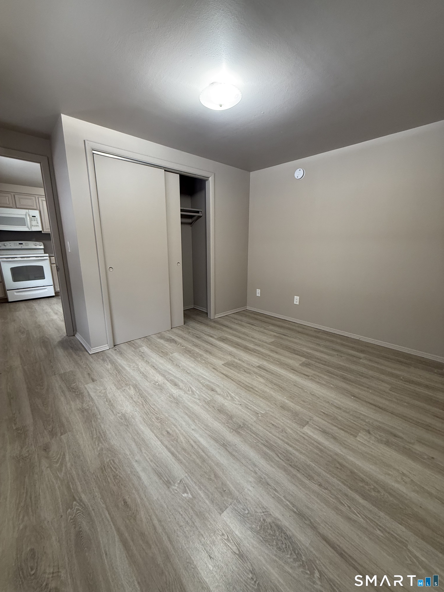 30 Bungay Road, Unit 5 Seymour, CT 06483 - Photo 13 of 14 an empty room with wooden floor and windows
