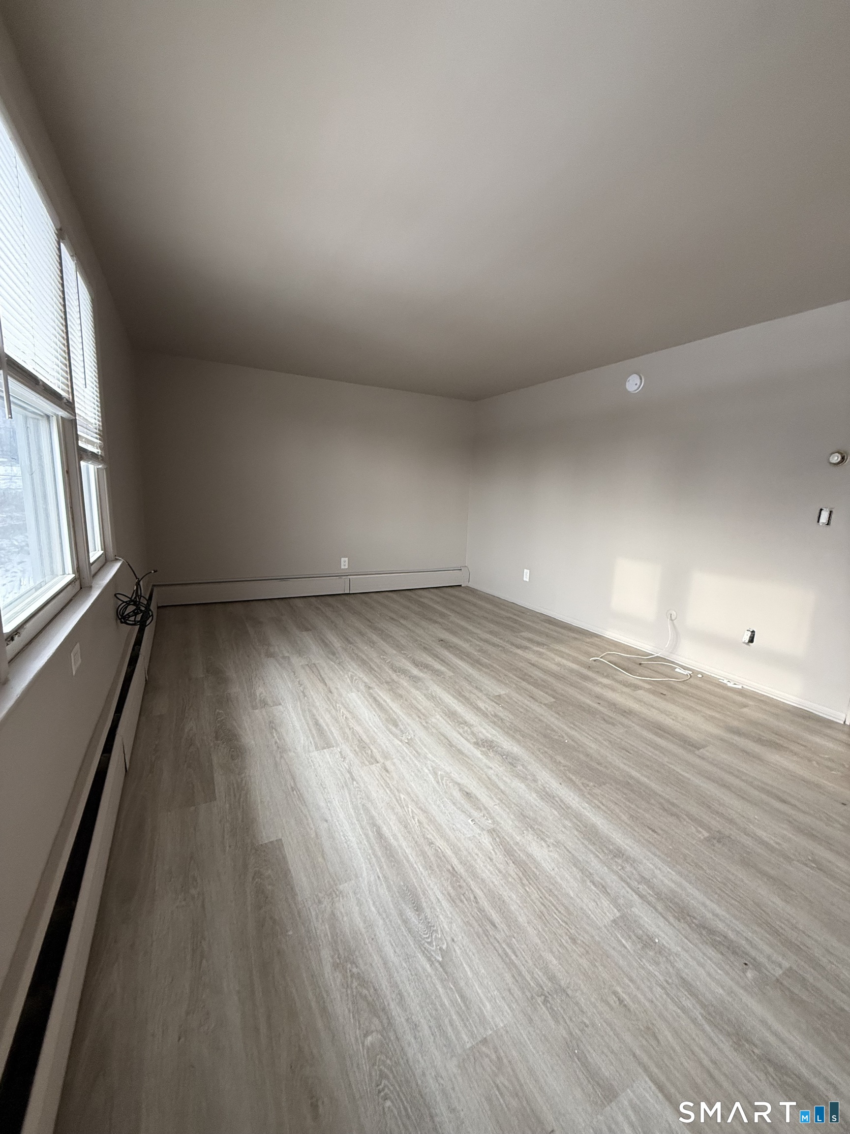 30 Bungay Road, Unit 5 Seymour, CT 06483 - Photo 7 of 14 wooden floor in an empty room with a window