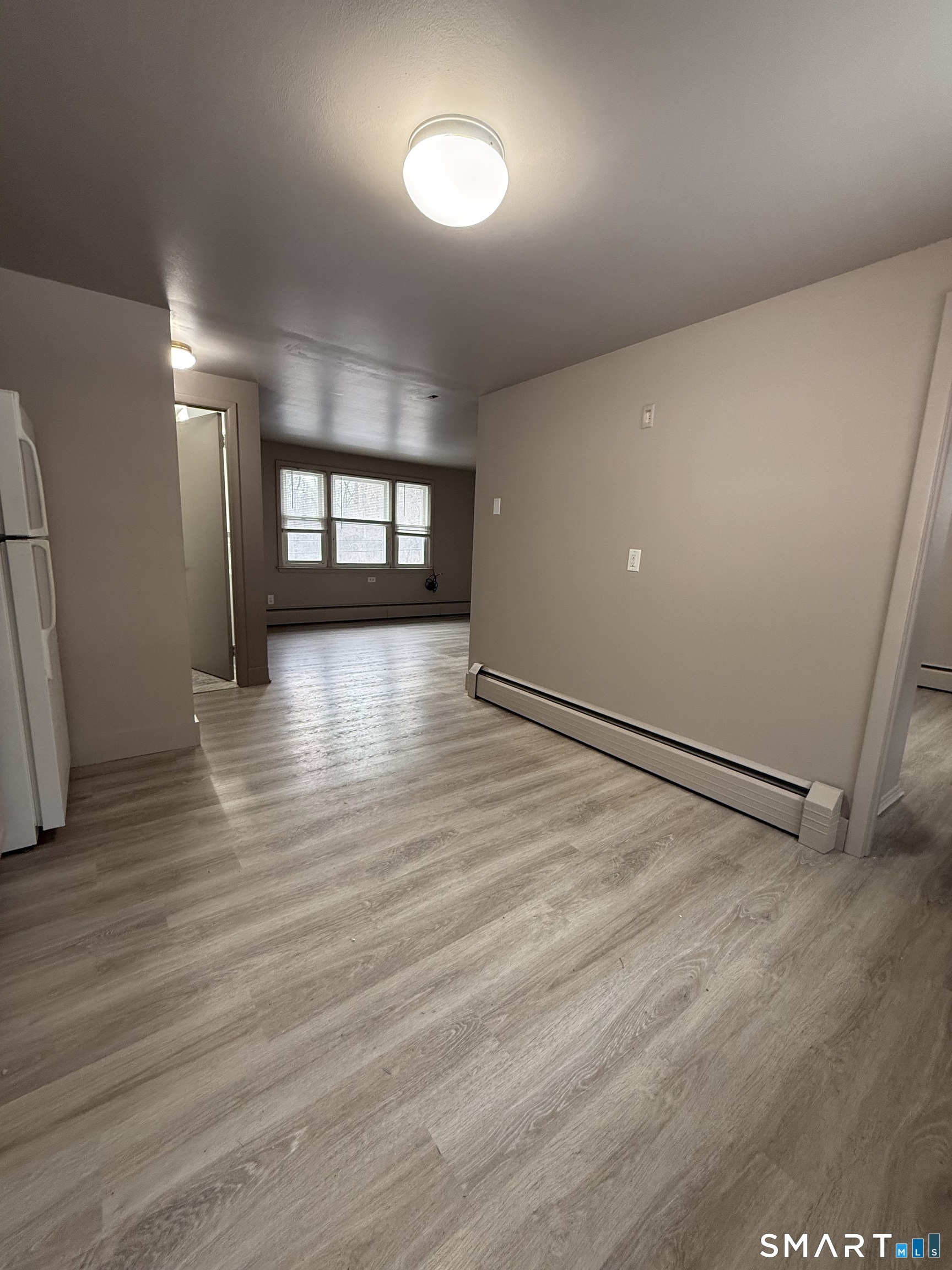 30 Bungay Road, Unit 5 Seymour, CT 06483 - Photo 9 of 14 an empty room with wooden floor and windows