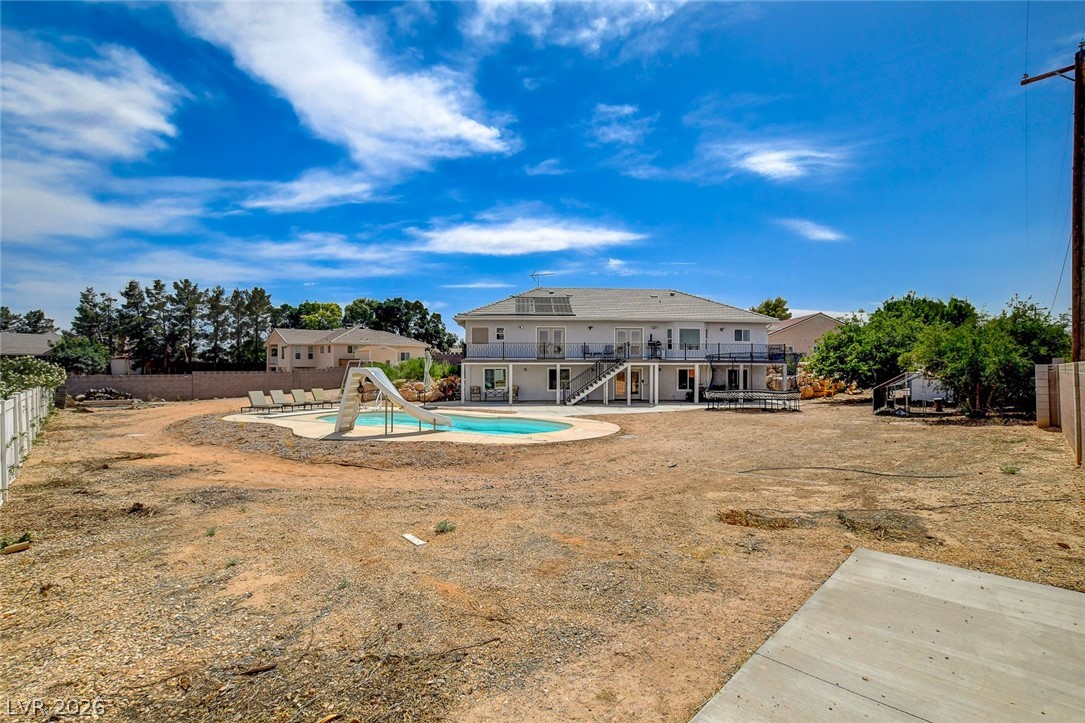 4362 Thistle Street Logandale, NV 89021 - Photo 81 of 99 An inviting pool with a slide and ample outdoor space highlight this private backyard oasis.
