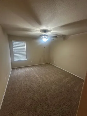 an empty room with a empty space and windows