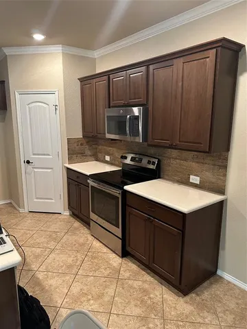 a kitchen with kitchen island a stove a sink and a refrigerator