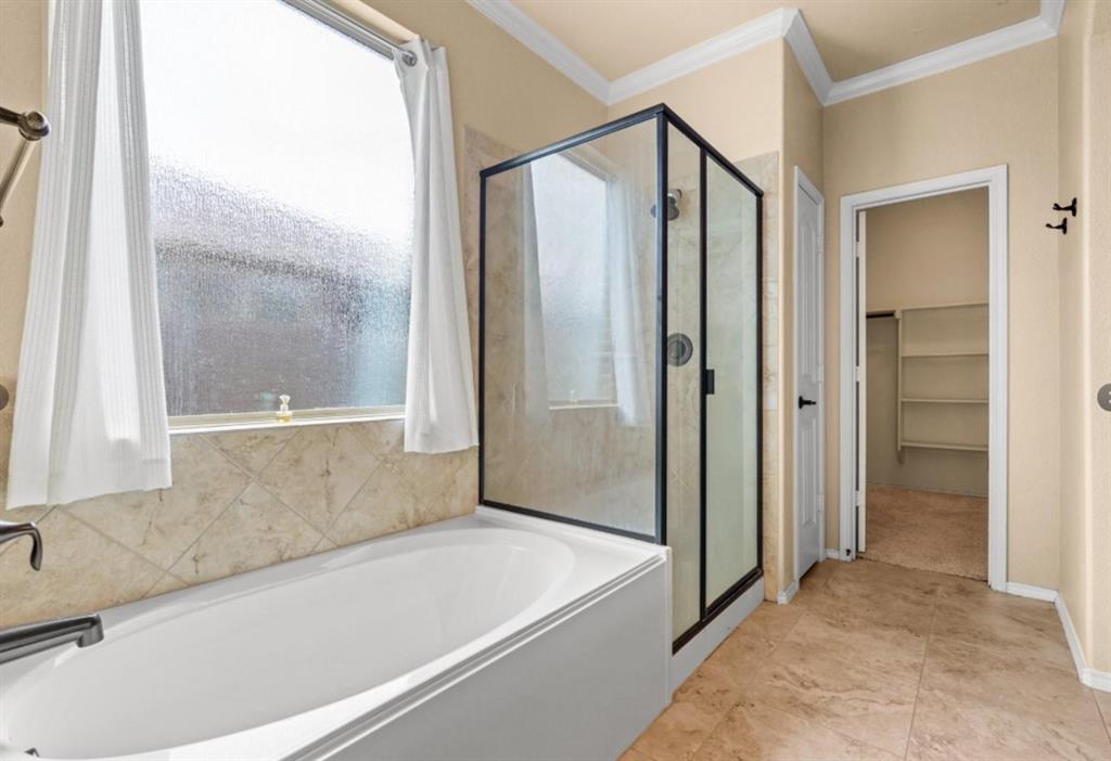 8404 Sioux Trail Aubrey, TX 76227 - Photo 3 of 20 a bathroom with a bathtub and a shower