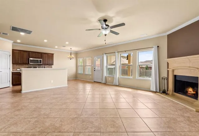 a view of a livingroom with furniture a fireplace and window