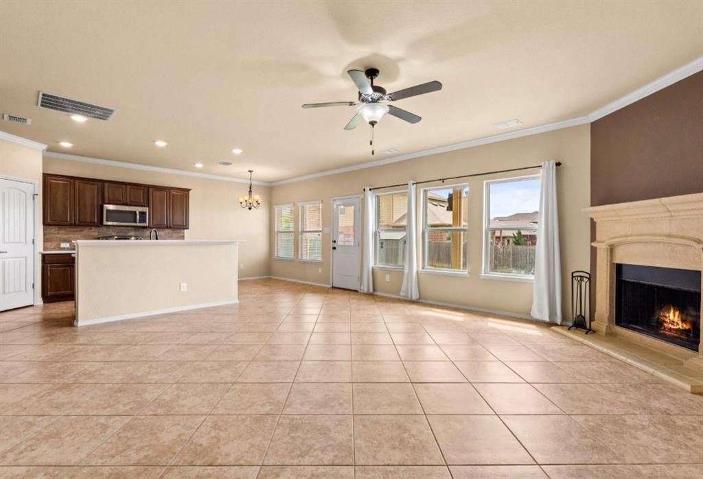8404 Sioux Trail Aubrey, TX 76227 - Photo 4 of 20 a view of a livingroom with furniture a fireplace and window