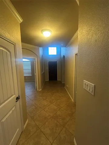 a view of a hallway with wooden shelves
