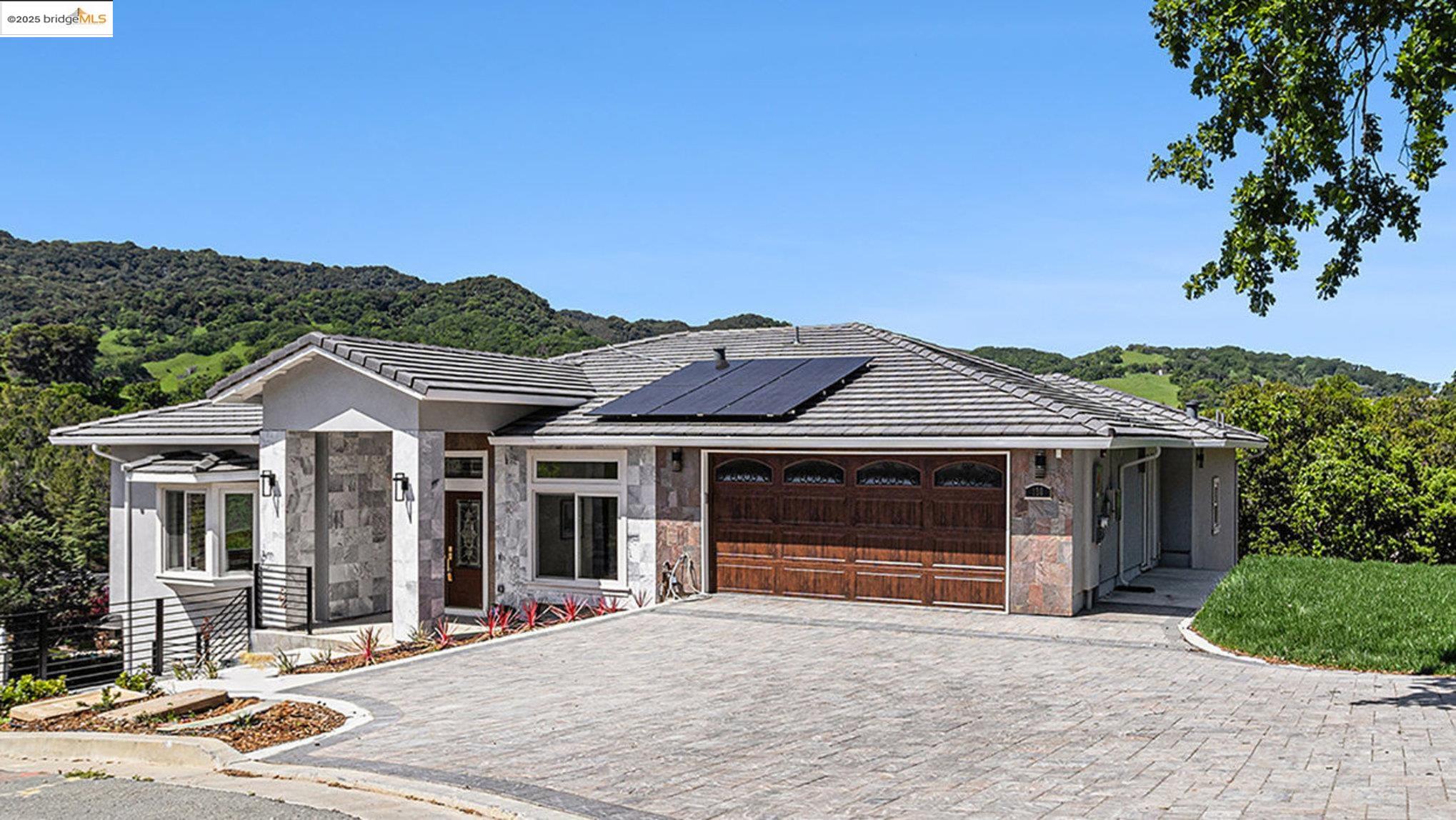 a front view of a house with a garden