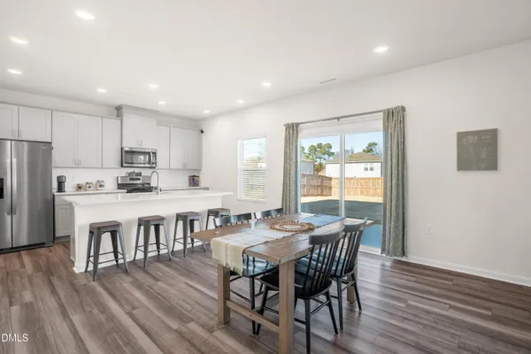 a view of kitchen with cabinets table and chairs