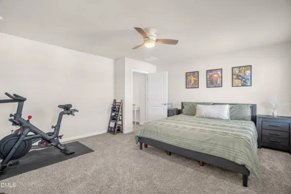 a bedroom with a bed and gym equipment