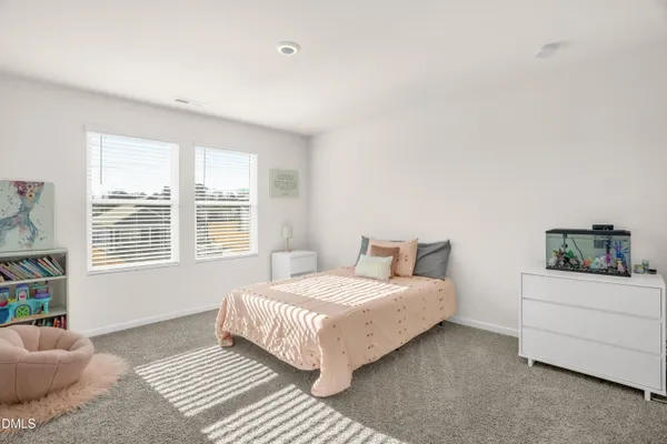 a bedroom with a bed and a chair