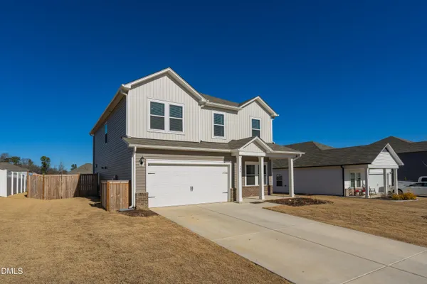 a view of a house with a yard and garage