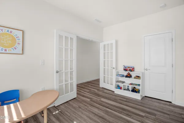 a view of a room with wooden floor and closet