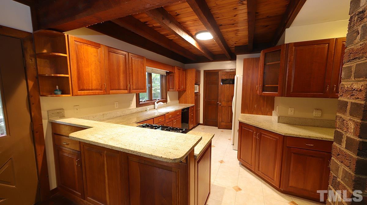 2413 Pleasant Union Church Road Raleigh, NC 27614 - Photo 7 of 30 Beautiful granite counters and solid cherry cabinets with a view out back.