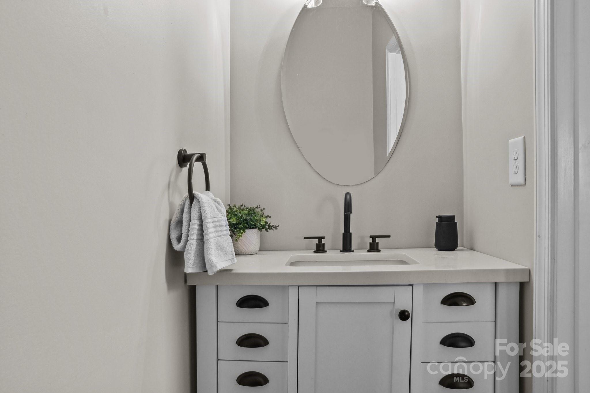 7520 West Berkeley Road Denver, NC 28037 - Photo 12 of 38 a bathroom with a sink and a mirror