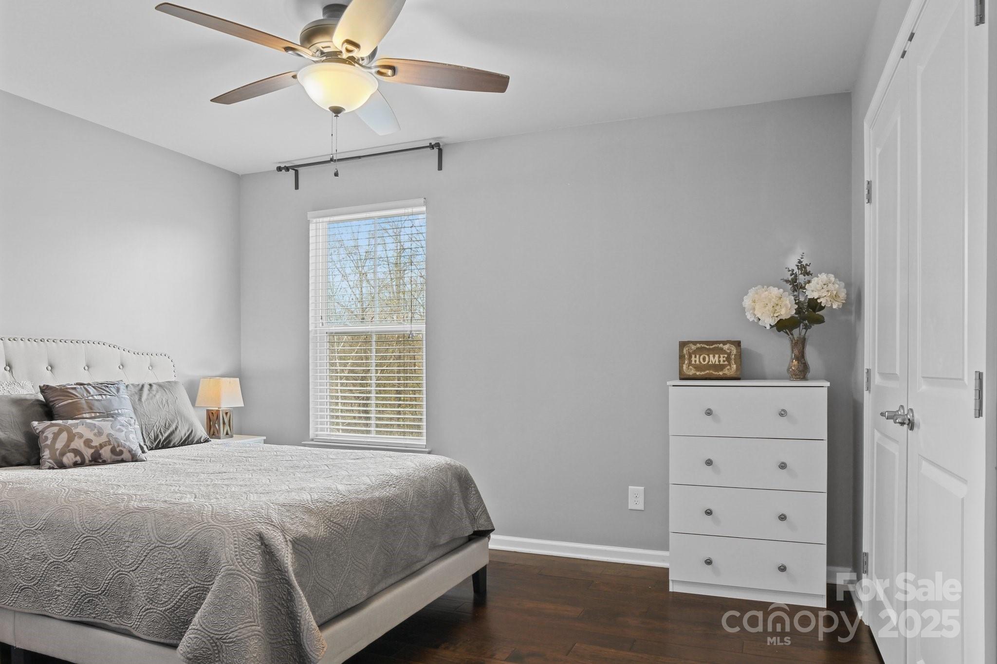 7520 West Berkeley Road Denver, NC 28037 - Photo 21 of 38 a bedroom with a bed and a chandelier