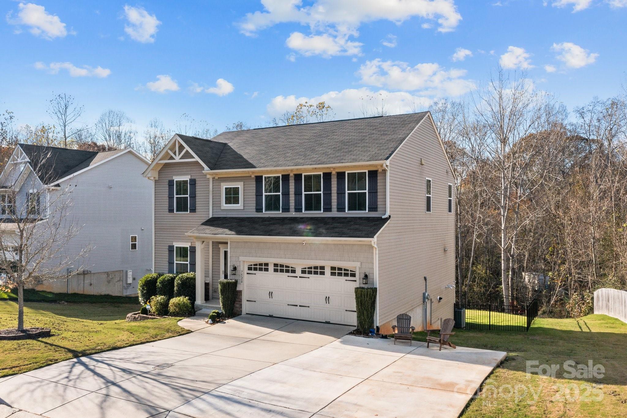 7520 West Berkeley Road Denver, NC 28037 - Photo 3 of 38 a front view of a house with a garden