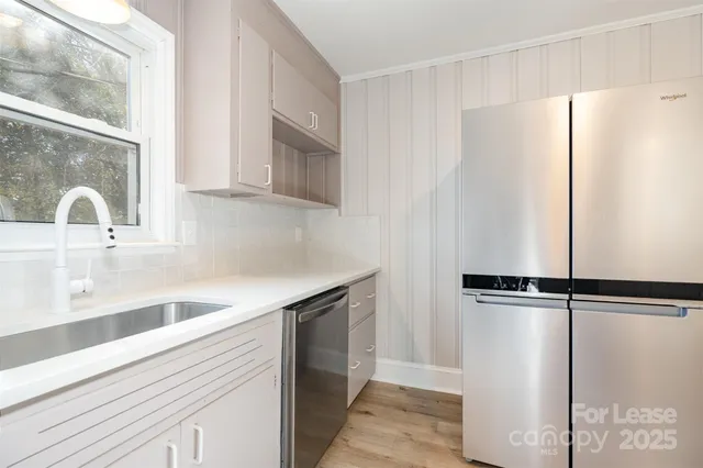 a kitchen with a refrigerator and a sink