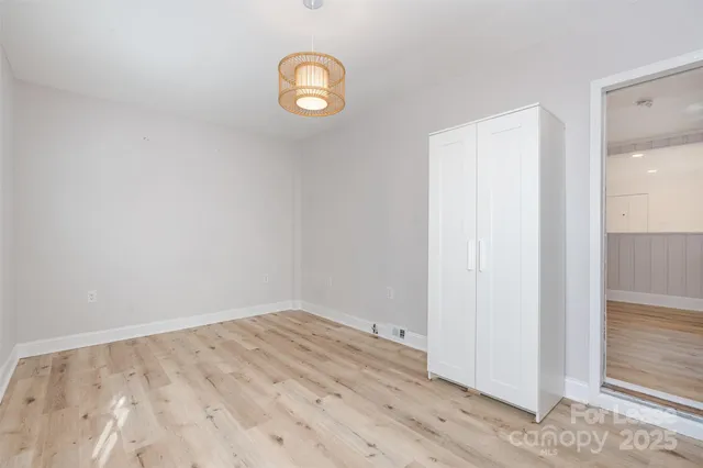 an empty room with wooden floor