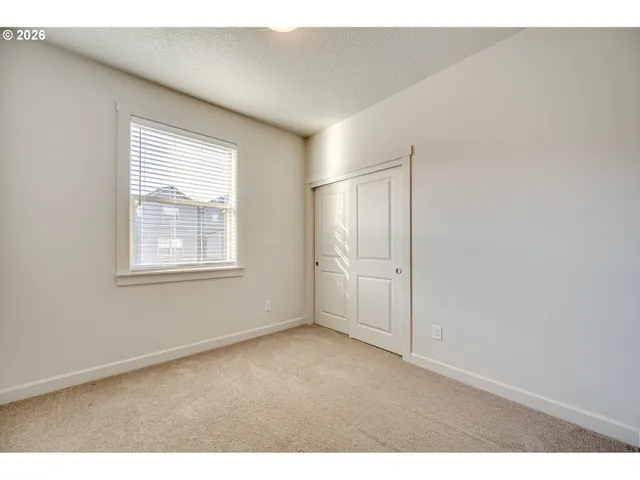 a view of empty room with ceiling fan