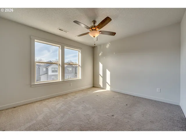 a bathroom with a granite countertop sink toilet a mirror and shower