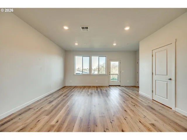 a view of a kitchen cabinets and wooden floor