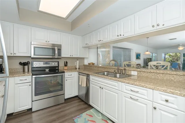 a kitchen with sink cabinets and stainless steel appliances