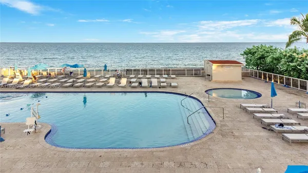 a view of a swimming pool with seating