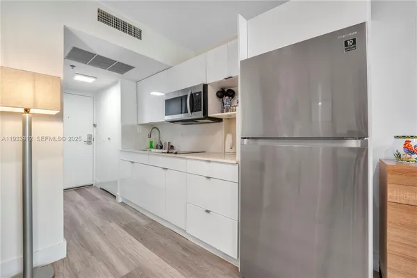 a kitchen with a refrigerator and countertop