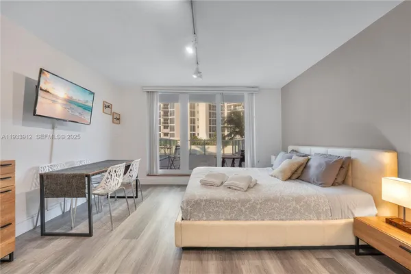 a bedroom with a bed and a flat screen tv