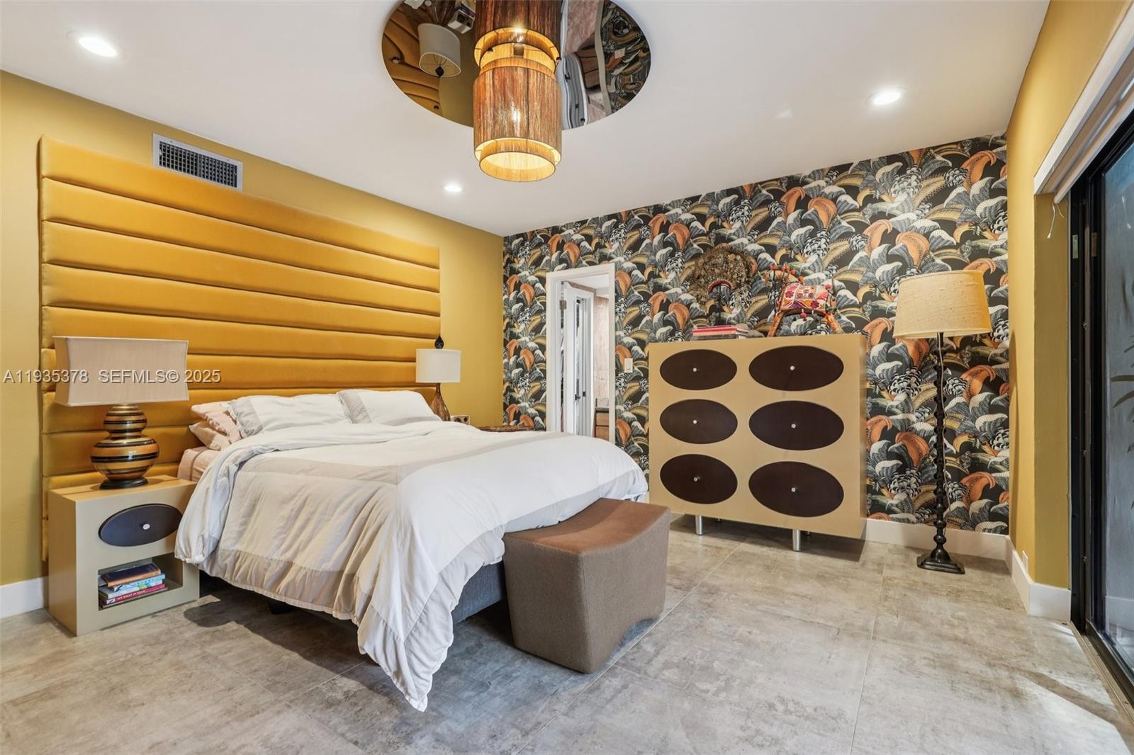 8375 Southwest 185th Terrace Cutler Bay, FL 33157 - Photo 12 of 35 a bedroom with a bed and a painting on the wall