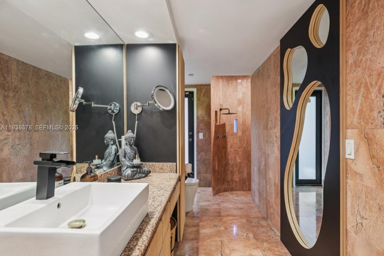 8375 Southwest 185th Terrace Cutler Bay, FL 33157 - Photo 14 of 35 a bathroom with a sink and a mirror