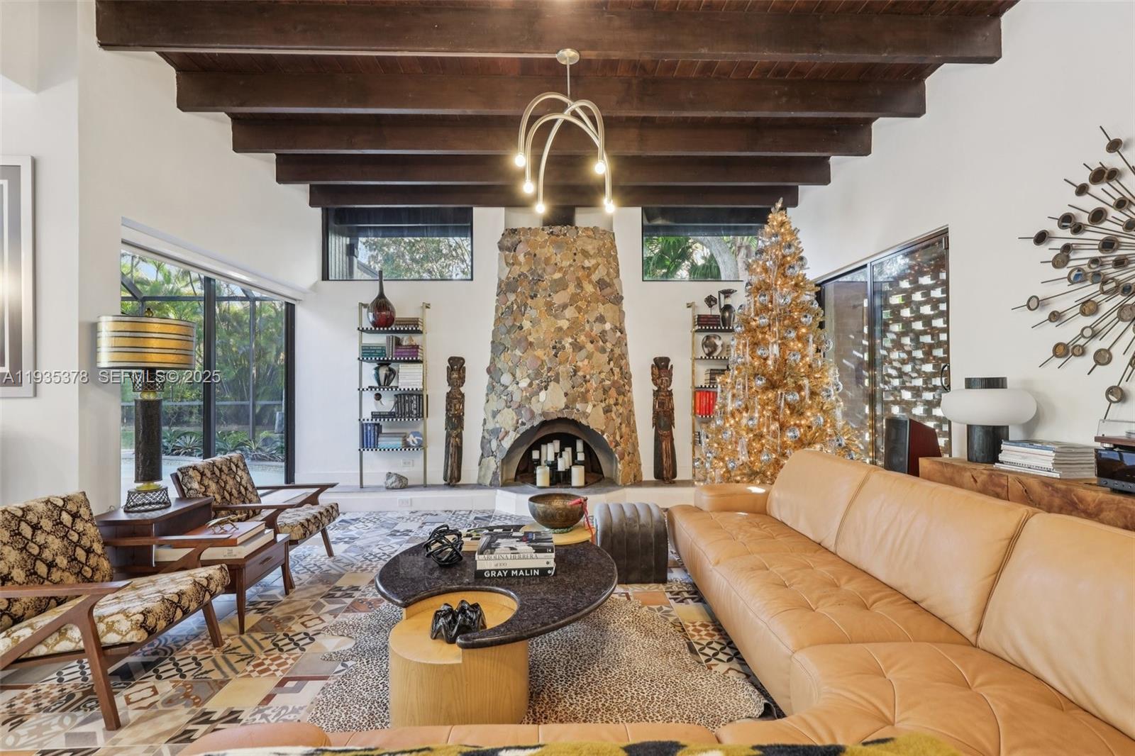 8375 Southwest 185th Terrace Cutler Bay, FL 33157 - Photo 2 of 35 a living room with furniture chandelier and a fireplace