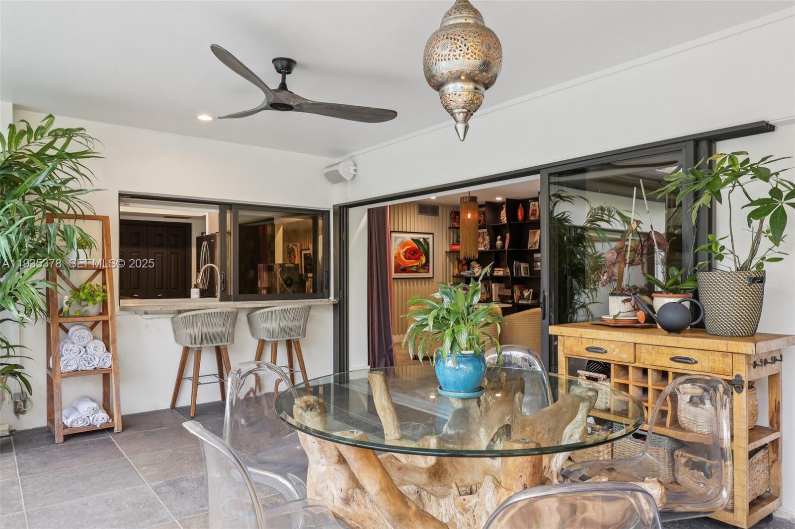 8375 Southwest 185th Terrace Cutler Bay, FL 33157 - Photo 24 of 35 a dining room with furniture floor to ceiling window and potted plants