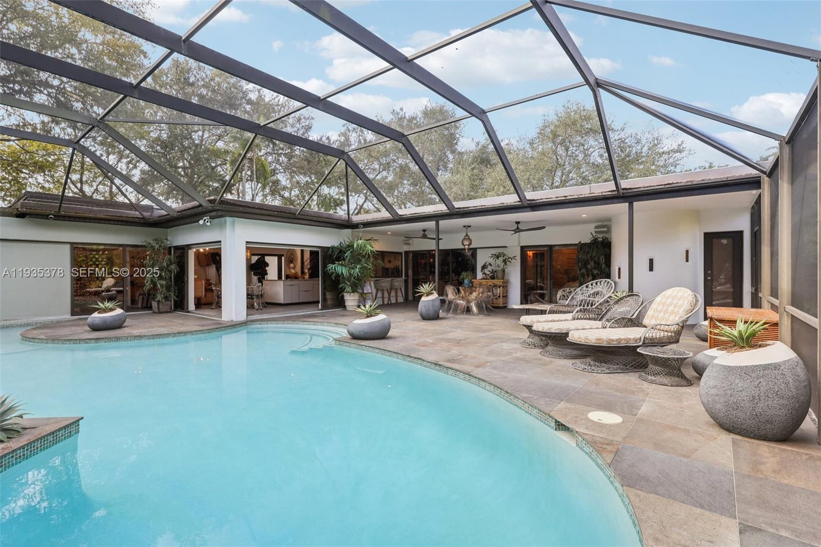 8375 Southwest 185th Terrace Cutler Bay, FL 33157 - Photo 26 of 35 a view of a house with backyard porch and sitting area