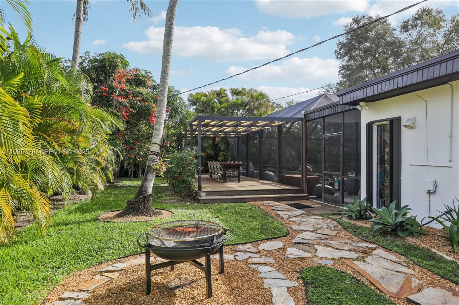 8375 Southwest 185th Terrace Cutler Bay, FL 33157 - Photo 30 of 35 a backyard of a house with barbeque oven table and chairs