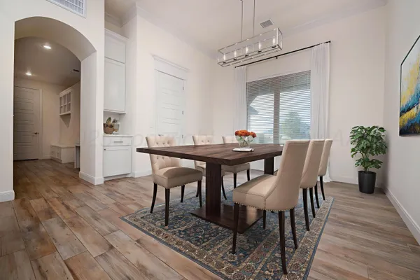 a view of a dining room with furniture window and wooden floor