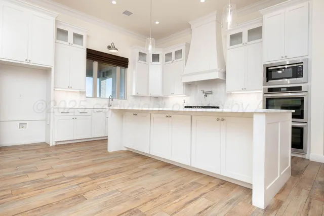 a kitchen with stainless steel appliances granite countertop a stove and a sink