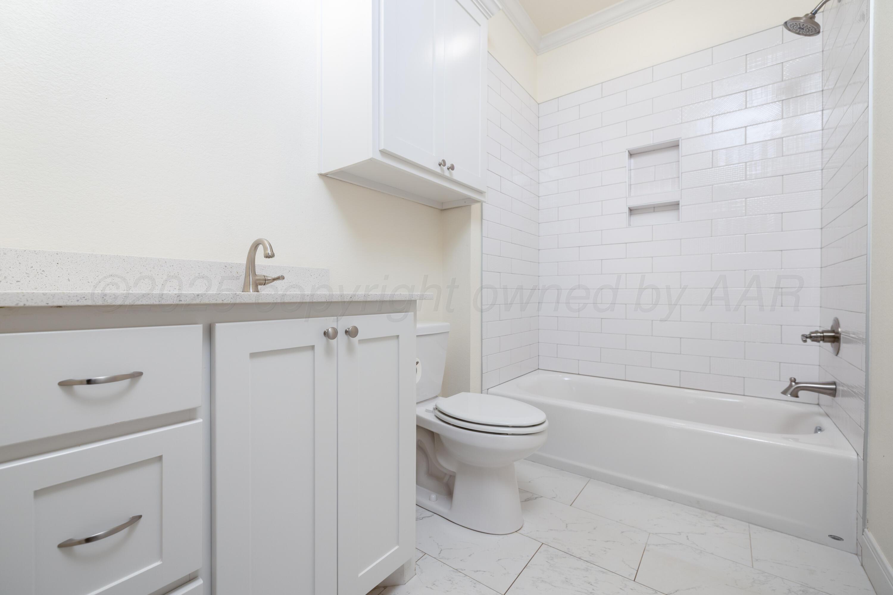 19350 Falcon Ridge Road Amarillo, TX 79124 - Photo 19 of 41 a bathroom with a sink a toilet and shower