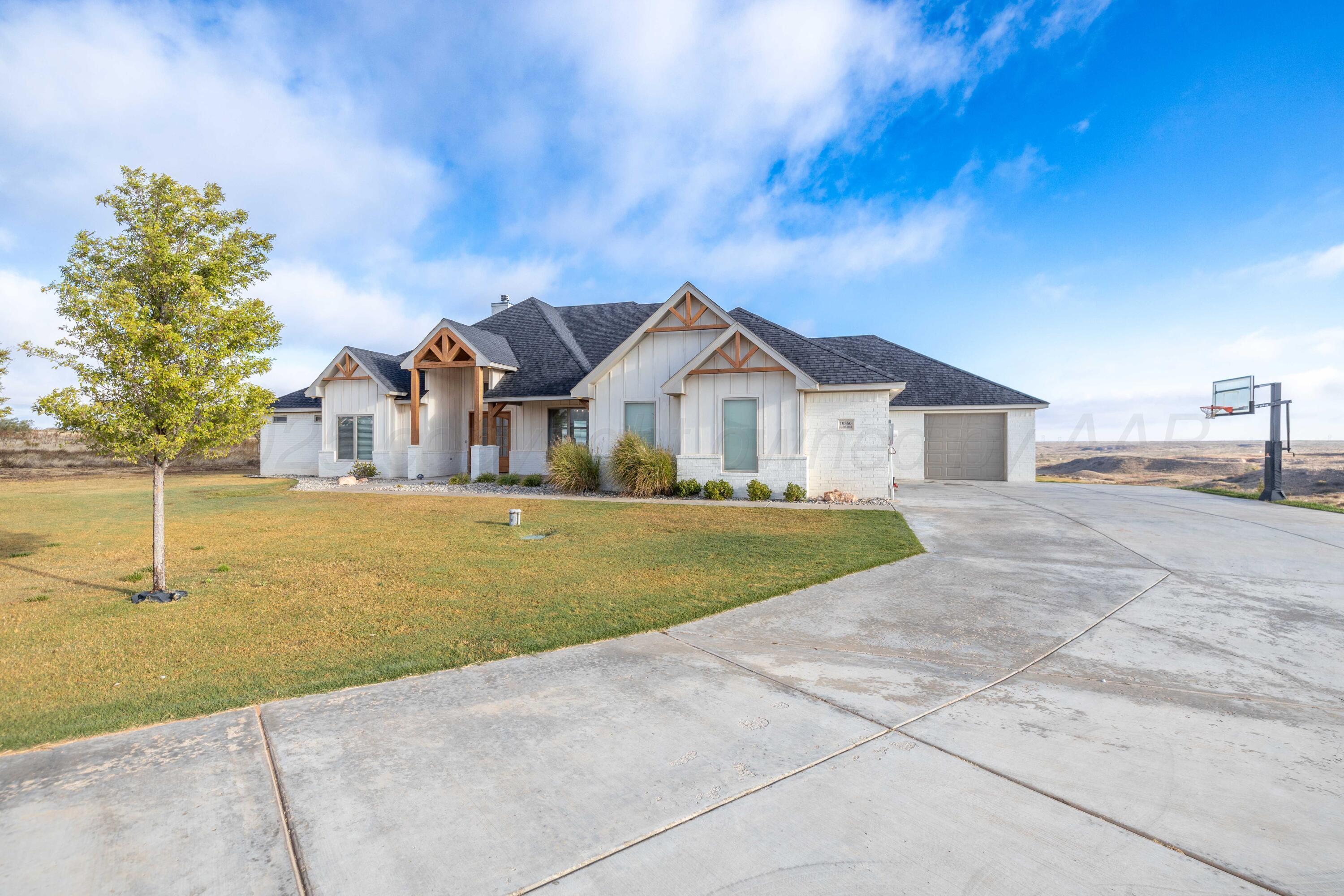19350 Falcon Ridge Road Amarillo, TX 79124 - Photo 2 of 41 a front view of a house with a yard
