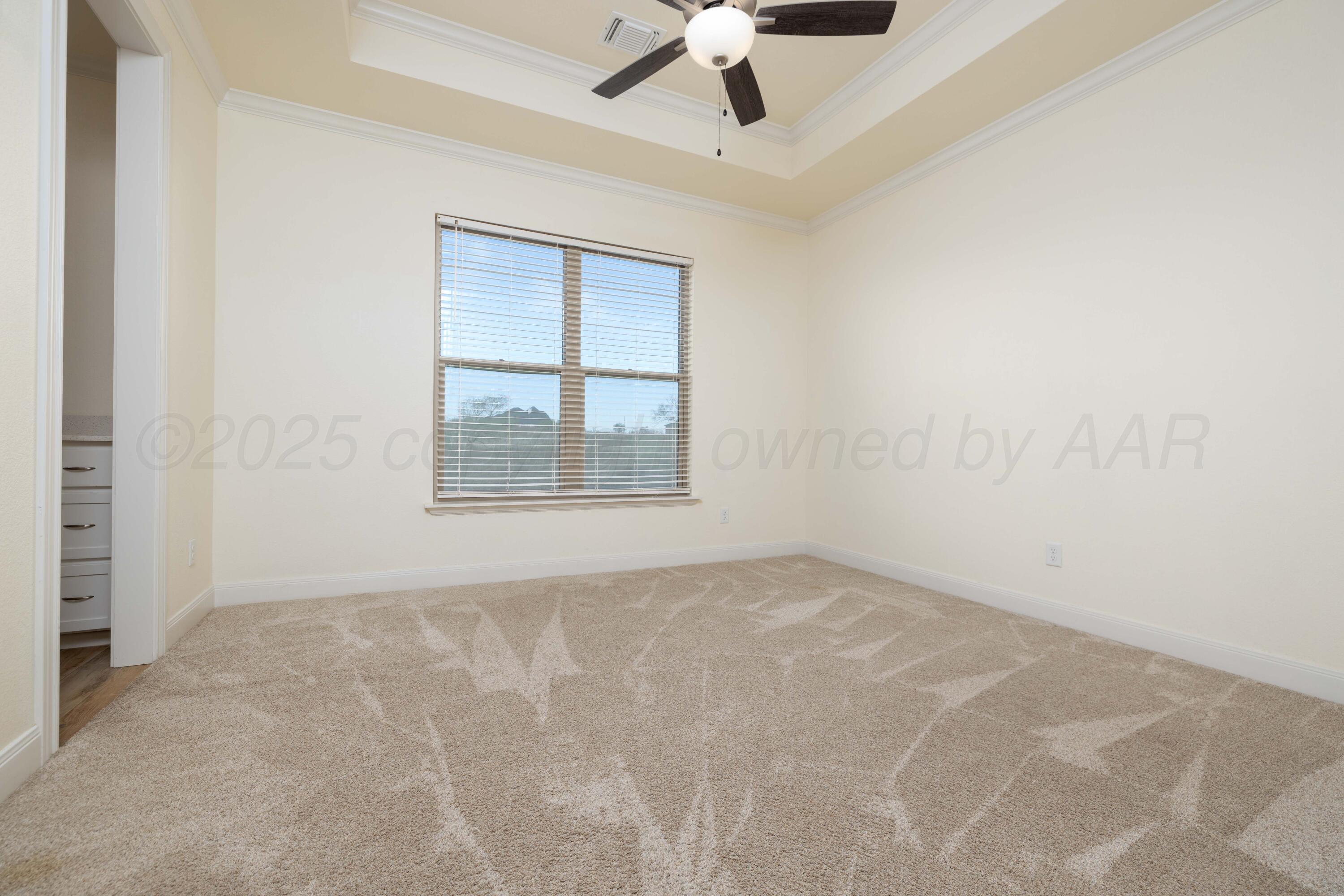 19350 Falcon Ridge Road Amarillo, TX 79124 - Photo 21 of 41 an empty room with a ceiling fan and windows