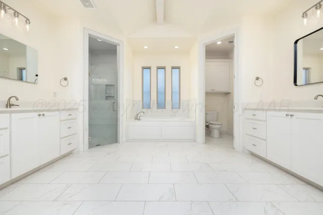 a bathroom with a vanity a sink a mirror and a bathtub