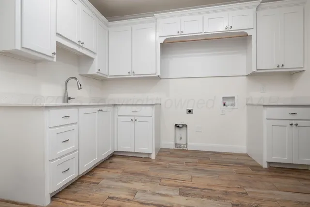 a kitchen with white cabinets and white appliances