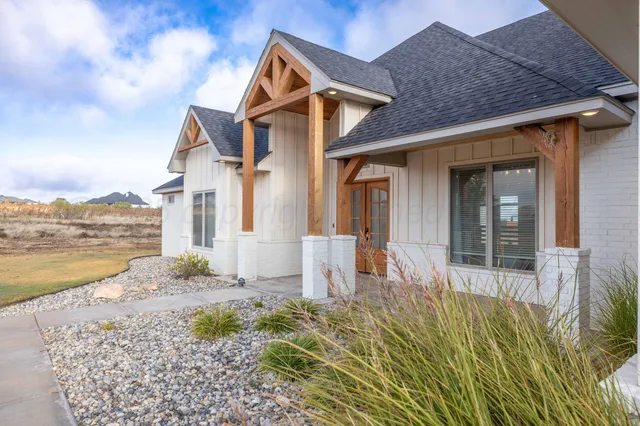 a front view of a house with a yard and ocean view