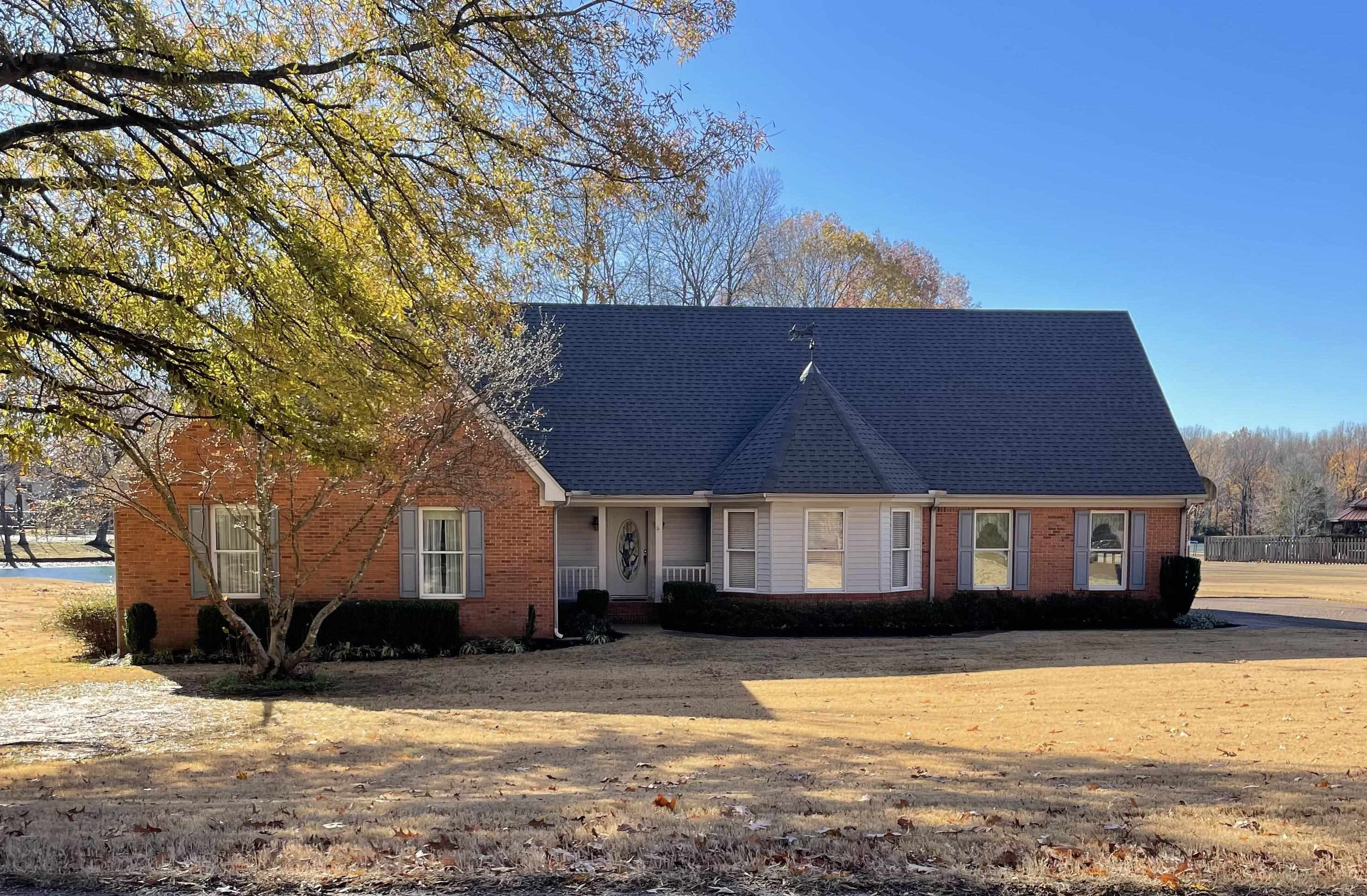 a view of a house with a yard covered with snow