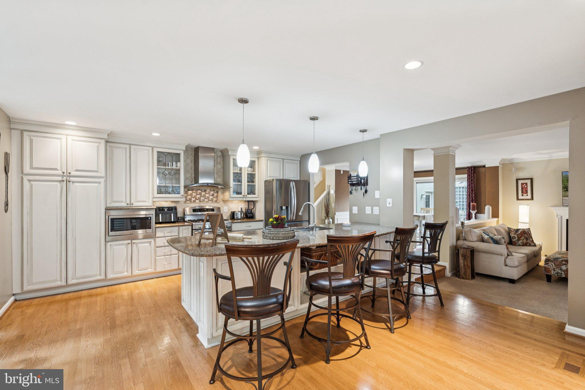 47660 Pennrun Way Sterling, VA 20165 - Photo 1 of 55 a view of a dining room and livingroom with furniture wooden floor a chandelier