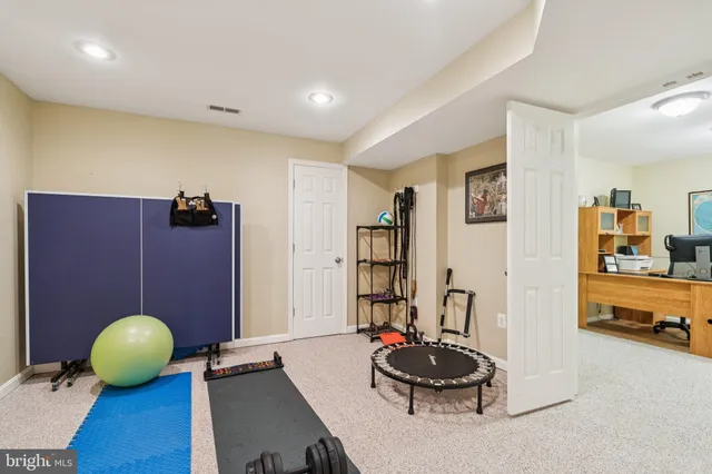 a room with gym equipment and a table