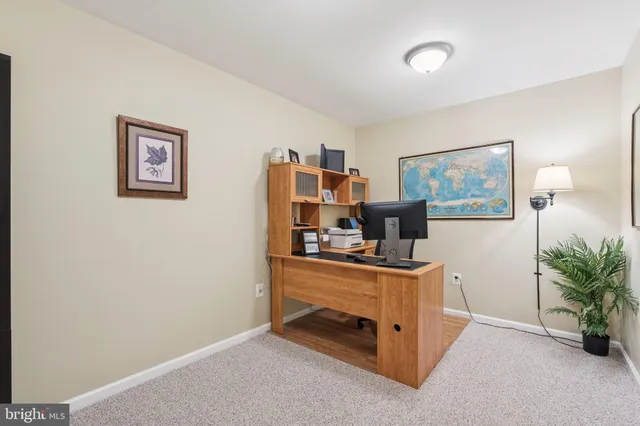 a bathroom with a granite countertop toilet sink mirror and shower